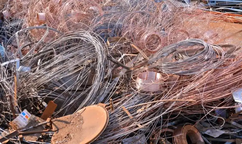 A pile of mixed copper and steel wire scrap showing unsorted metal that may receive lower pricing at a scrap yard.