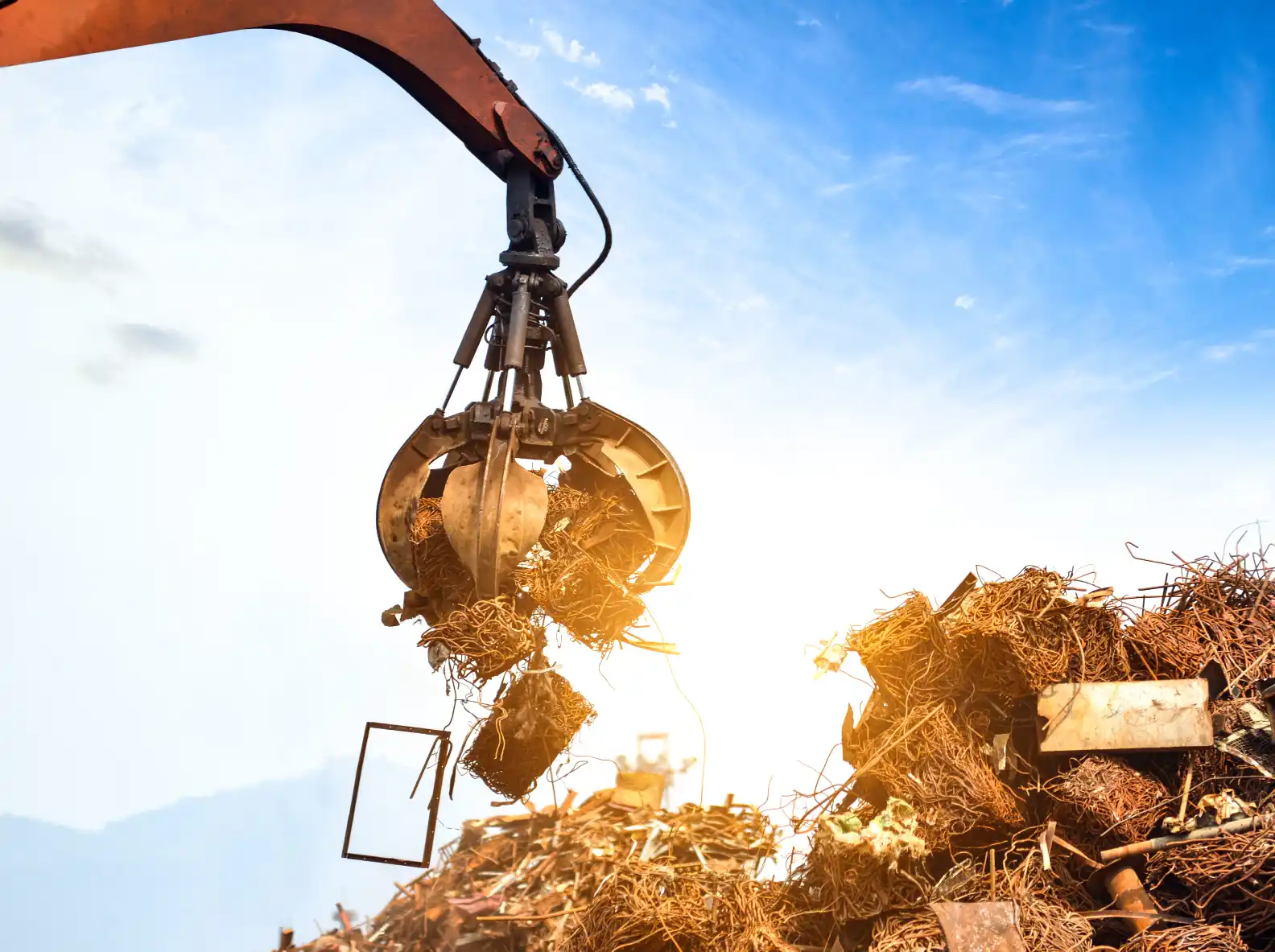 A close-up pile of mixed steel offcuts, rebar pieces and structural metal scraps from a Melbourne construction or demolition site.