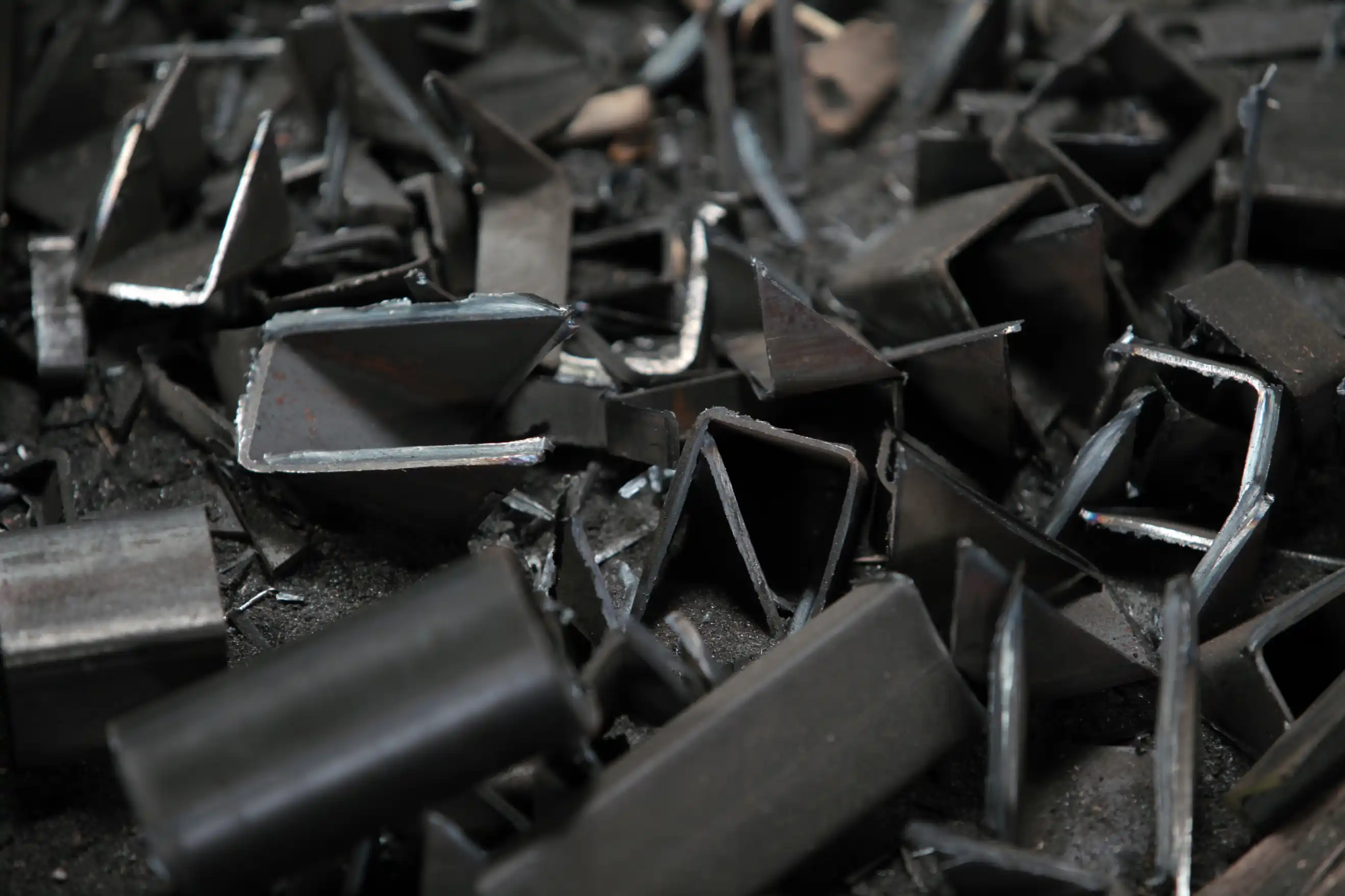 Pile of shiny aluminium metal shavings and turnings collected for recycling